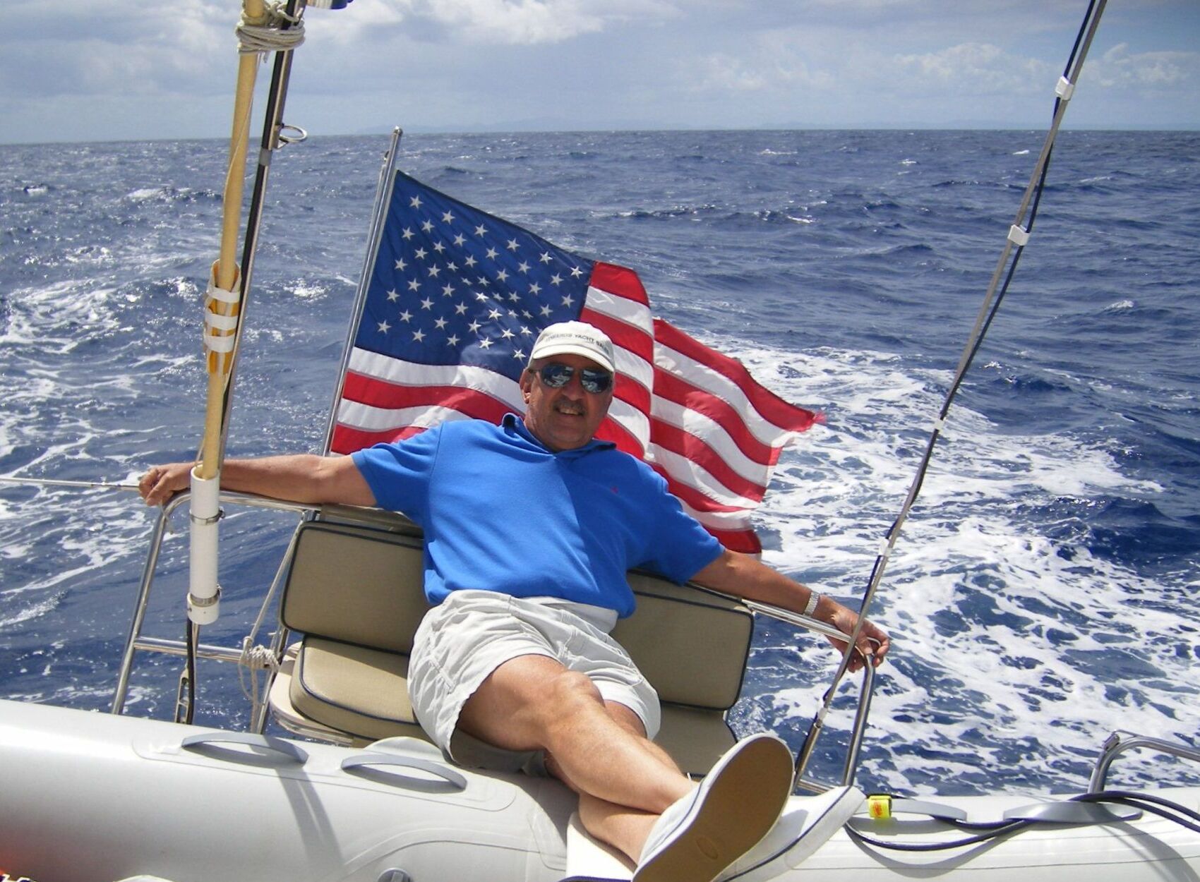Capt. Bob Cook offshore under sail, American flag flying
