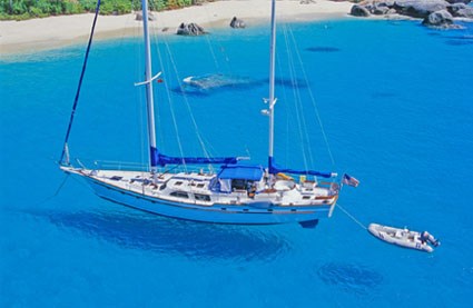 Sailing yacht anchored in clear blue water on arrival